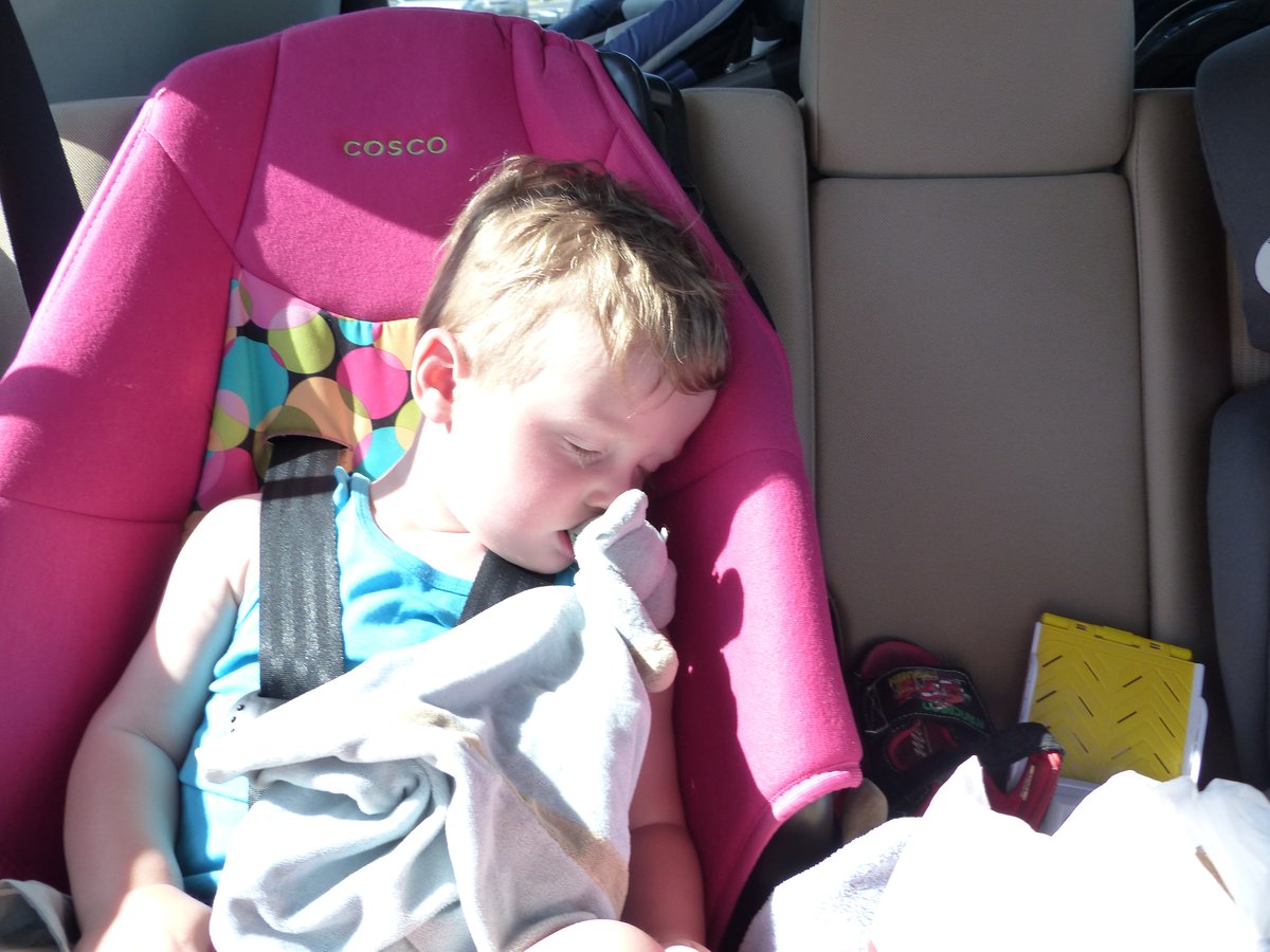 Vitus passed out in his car seat — the universal end-of-road-trip photo