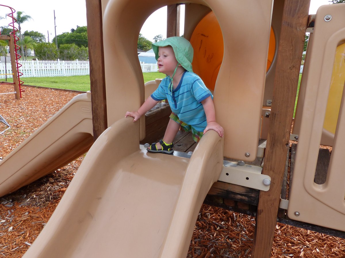 Vitus on the campground playground slide — determined and very pleased with himself