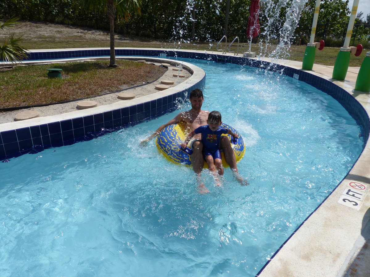 Both boys in the lazy river pool — floating and giggling