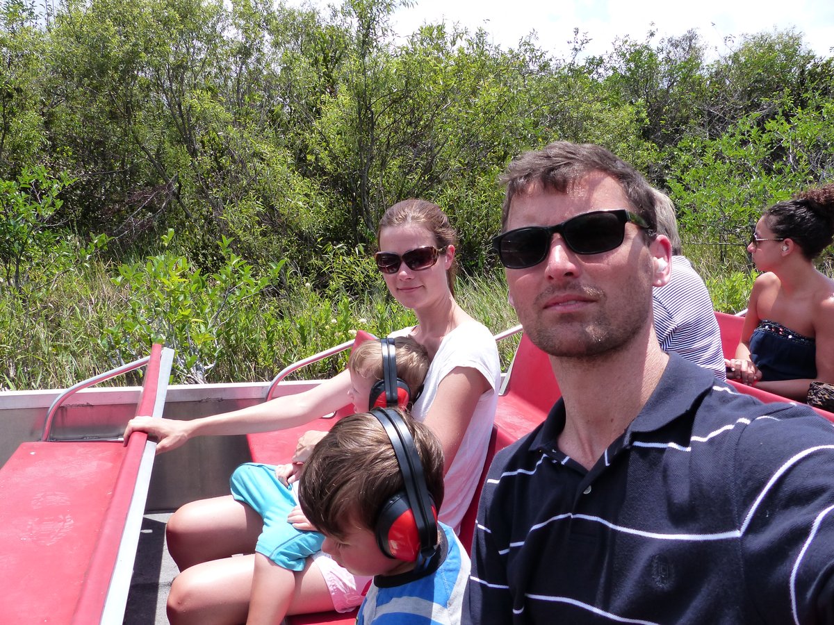 Family on the Everglades airboat — Jesper in front, kids with ear protection, marshland everywhere