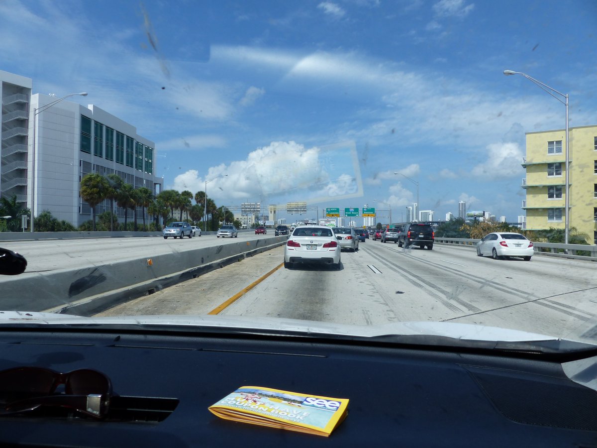 Driving on the highway towards Miami — palm trees, traffic, and the journey home