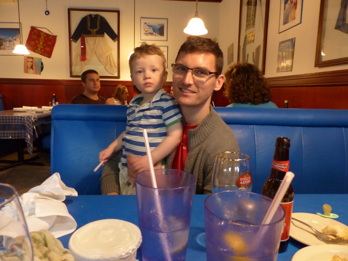 Restaurant dinner — Jesper holding Vitus while trying to eat with one hand