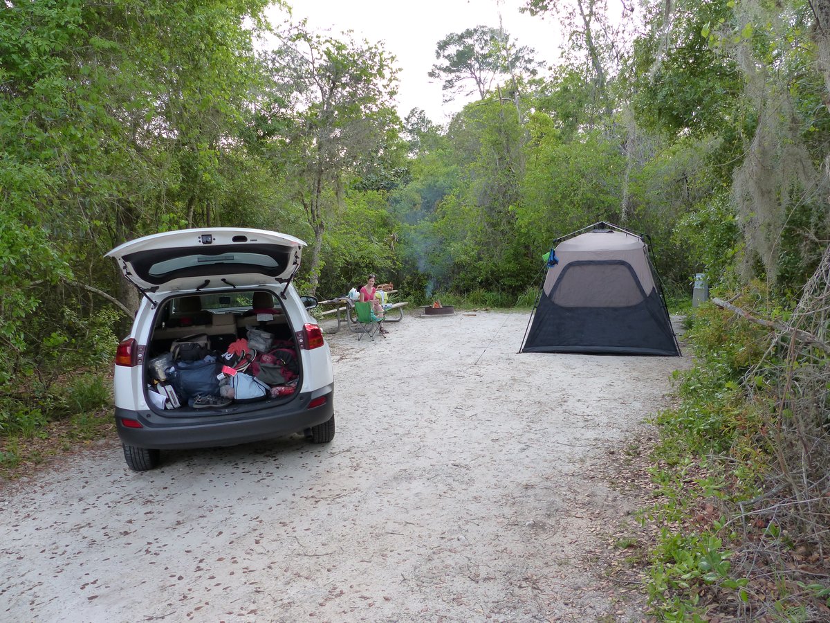 Our campsite with tent and car under beautiful Spanish moss trees