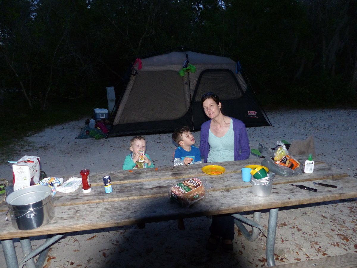 Evening dinner at the campsite — Line and the boys at the picnic table with the tent behind them