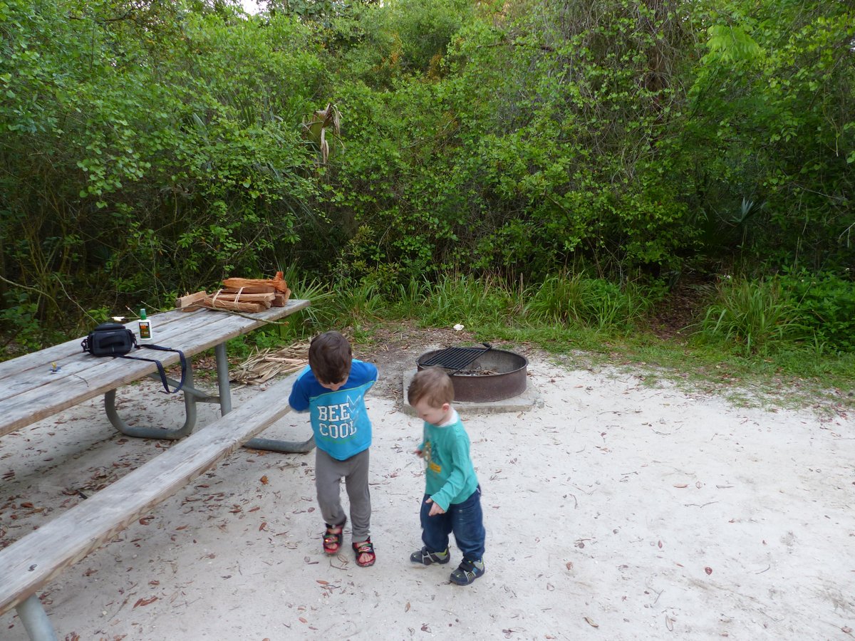 Noah and Vitus at the campsite picnic table — settling into camp life