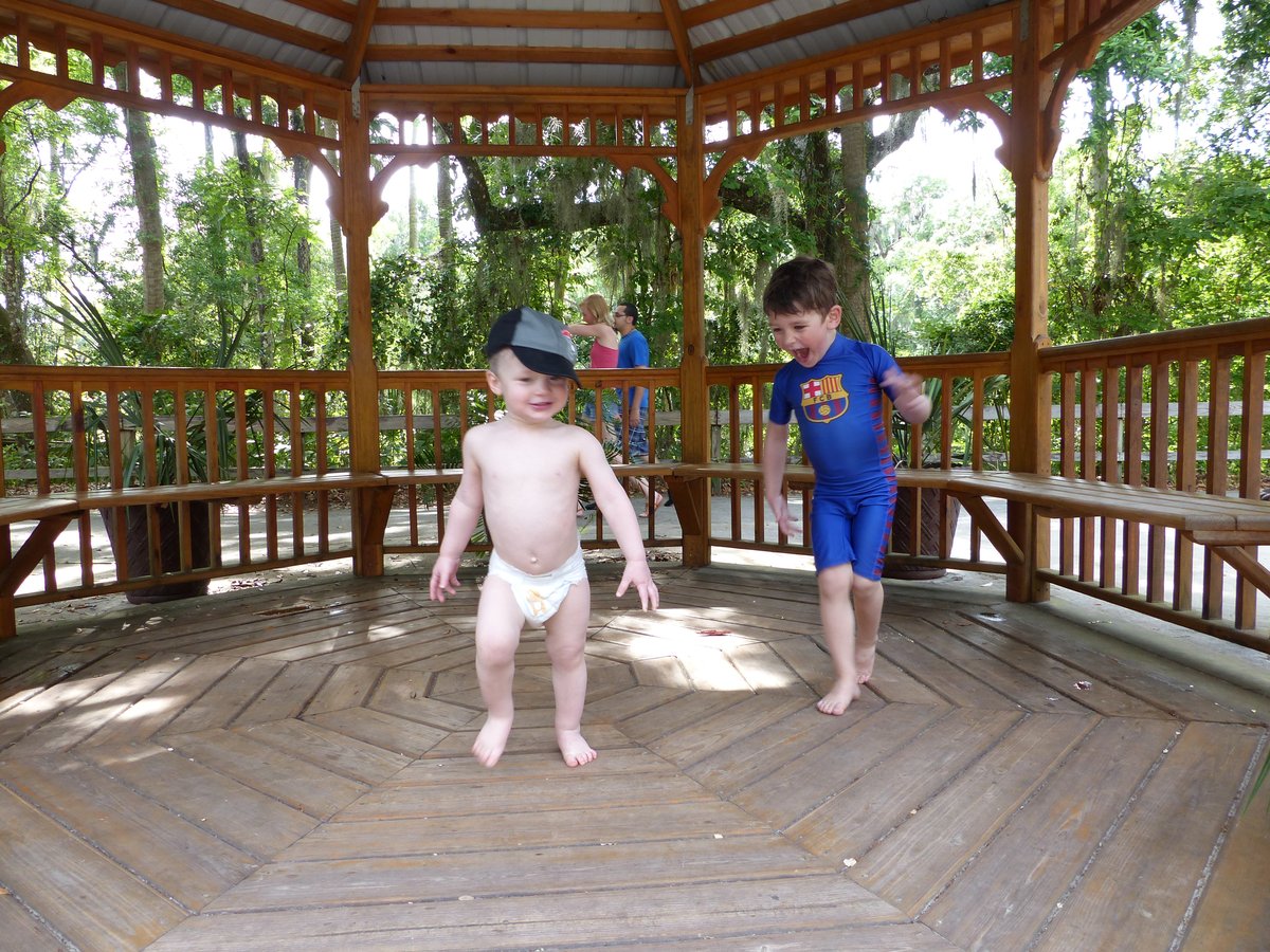 Both boys relaxing in a gazebo — Vitus in his diaper, Noah in his rashguard