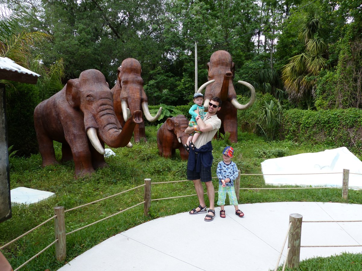 Jesper with both boys near the mammoth sculptures at the park entrance