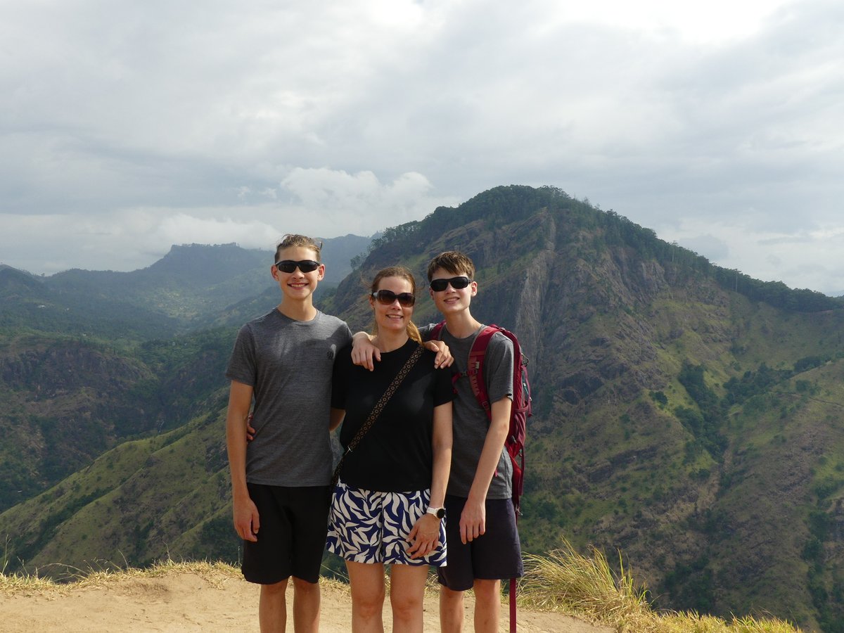 Noah, Line and Vitus at the Little Adam's Peak summit with the rock face behind