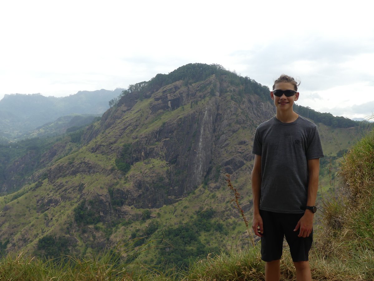 Vitus at the viewpoint with the steep green ridge of Ella Rock behind