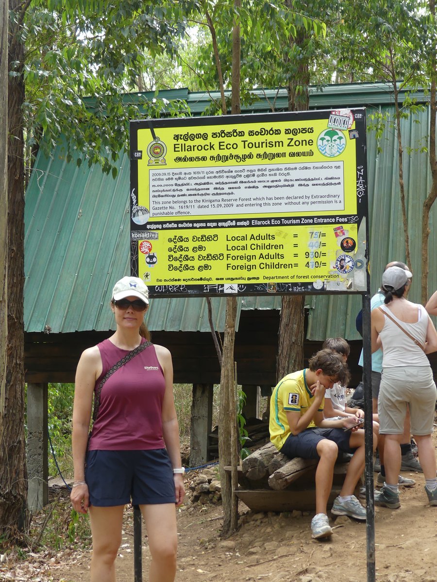 Line by the Ellarock Eco Tourism Zone sign listing local and foreign entrance fees