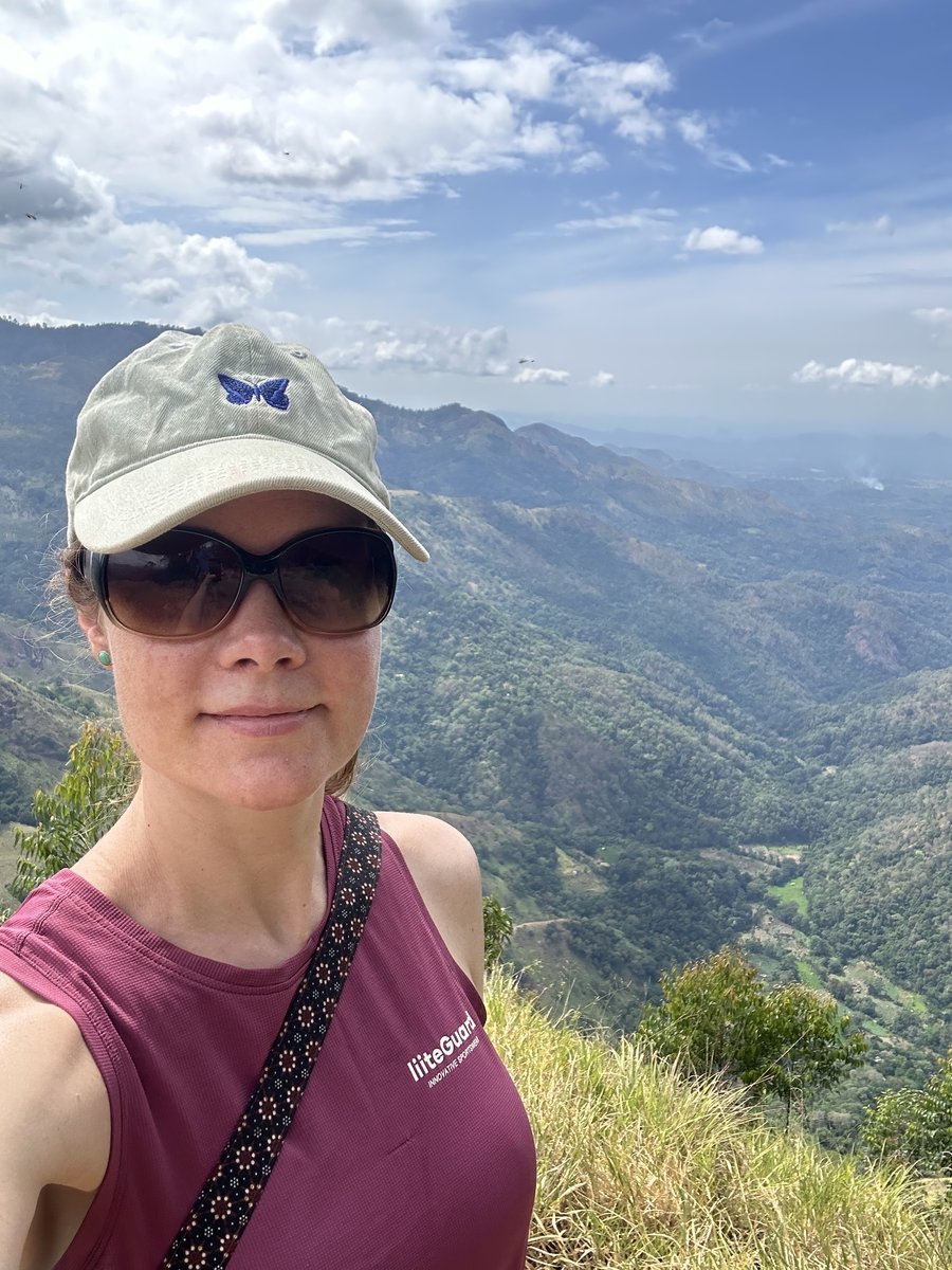 Line's selfie at the Ella Rock summit with the hills behind