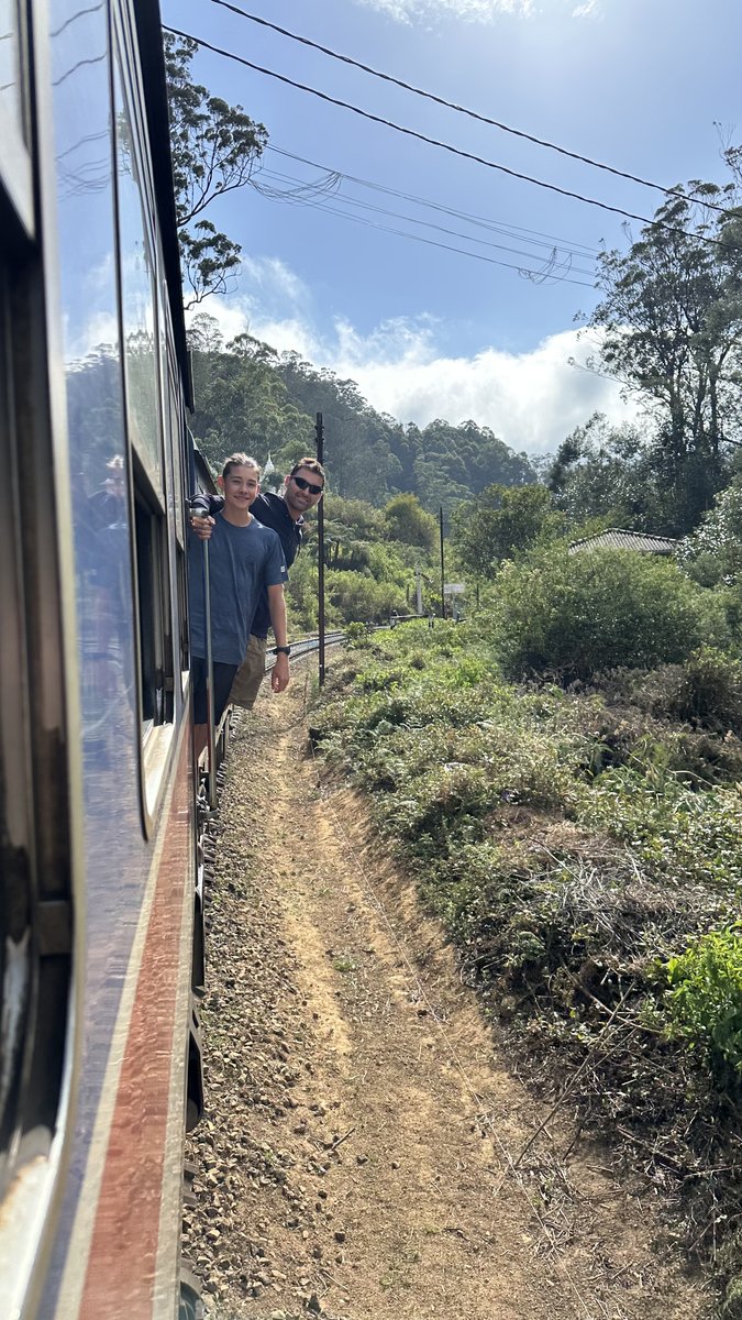 Noah and Jesper standing in the train doorway looking back down the track