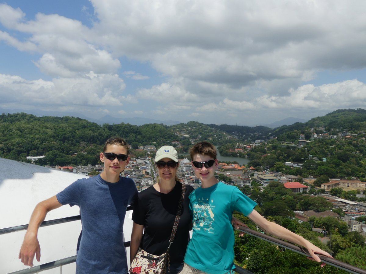 Noah, Line and Vitus on the platform behind the giant Buddha, Kandy and its lake below
