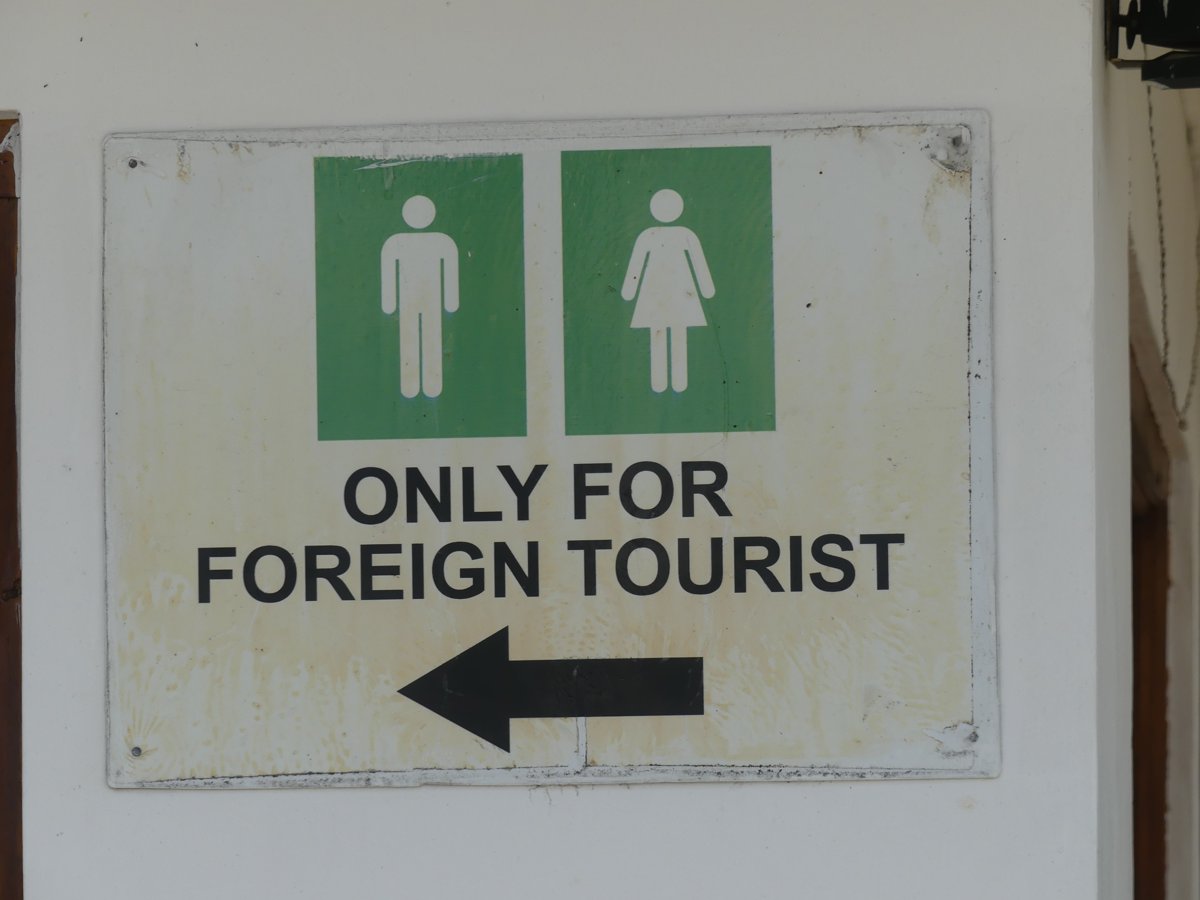 A sign pointing to toilets marked 'Only for foreign tourist'