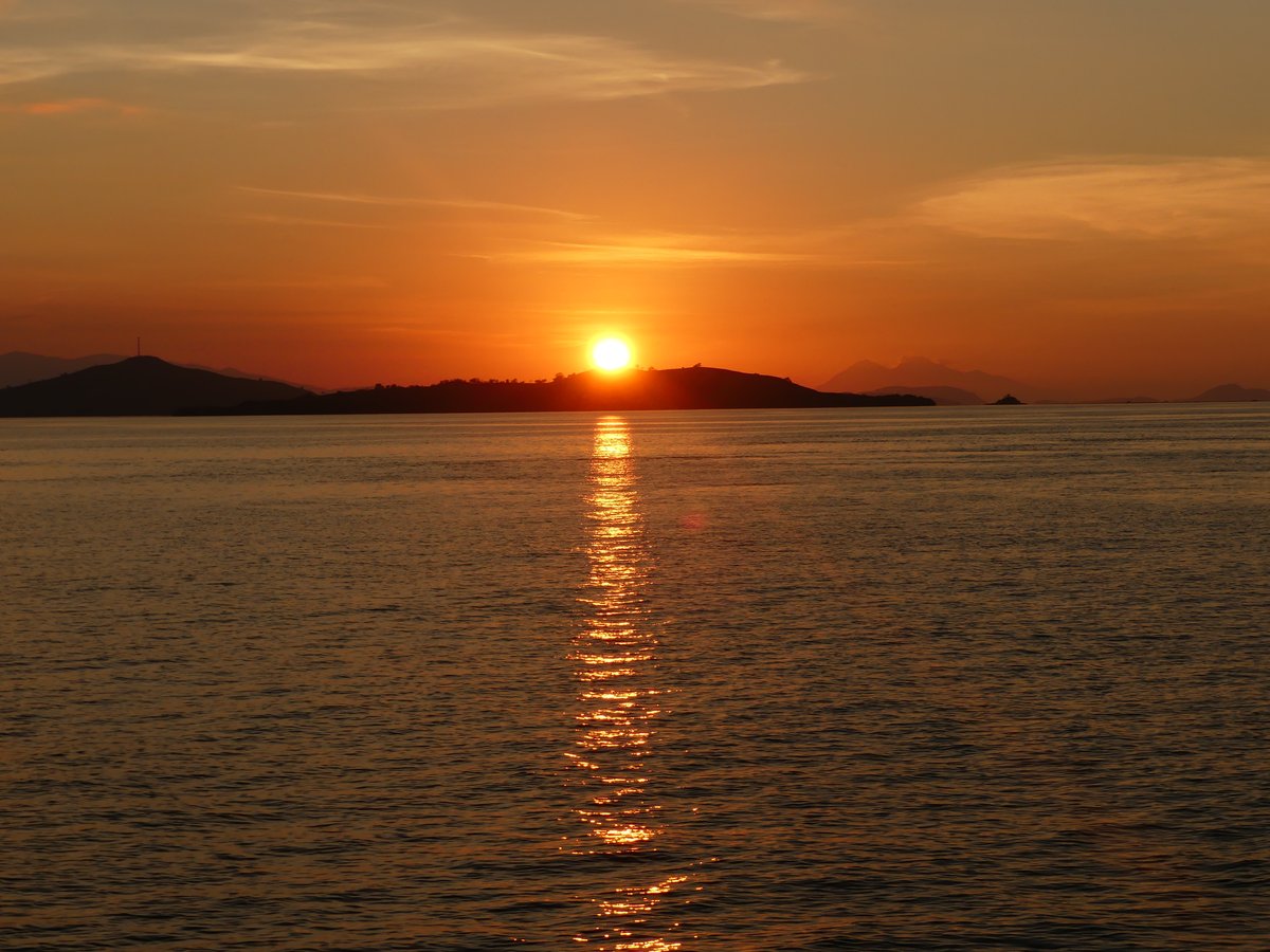 The sun setting over the islands of the Komodo archipelago