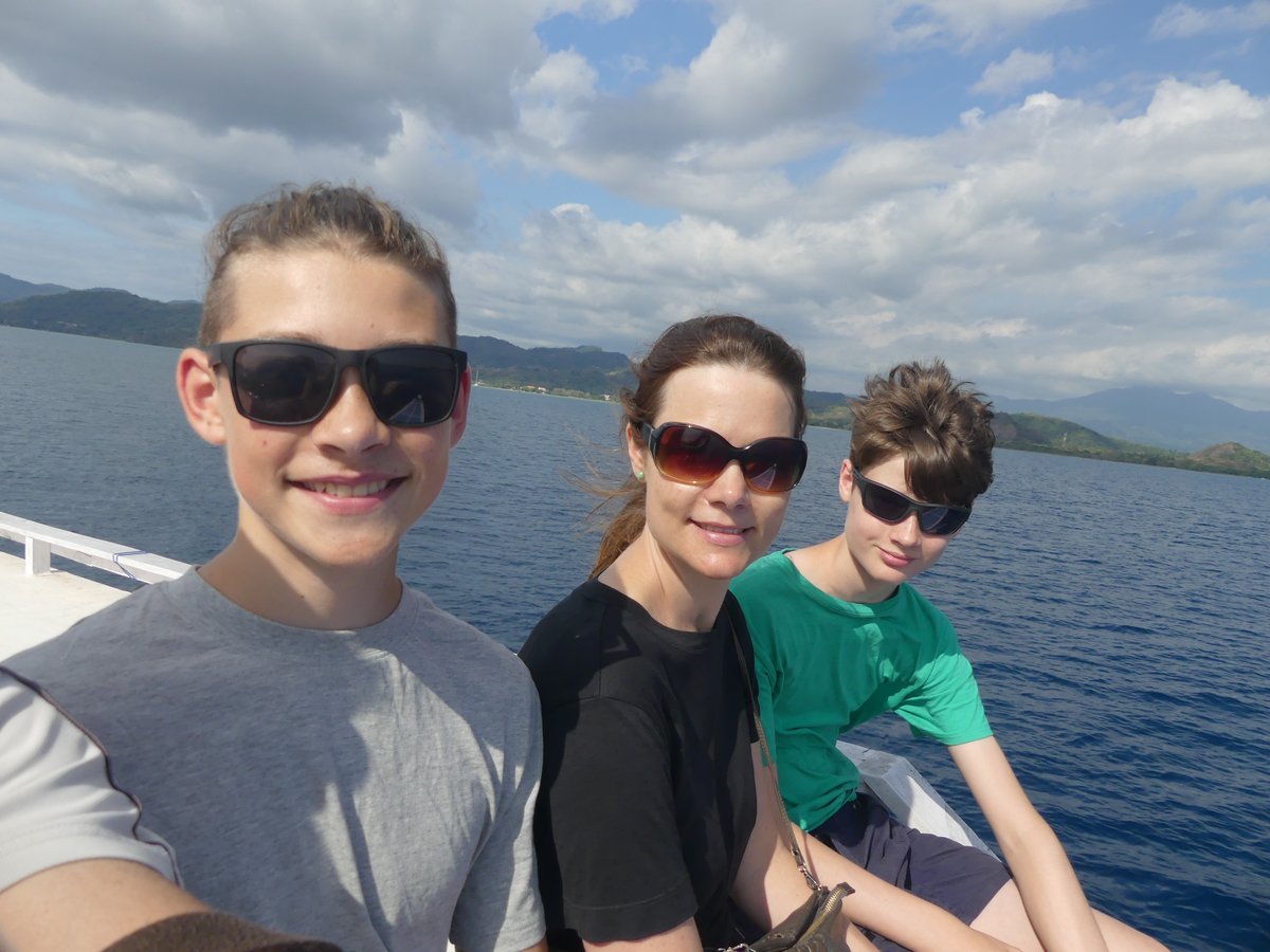 Noah, Line and Vitus selfie on the boat with the archipelago behind