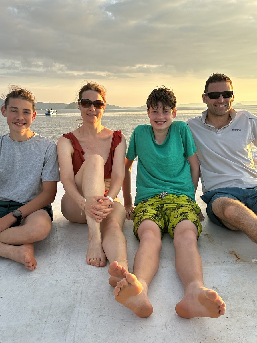 Noah, Line, Vitus and Jesper together on the boat roof, sunset behind
