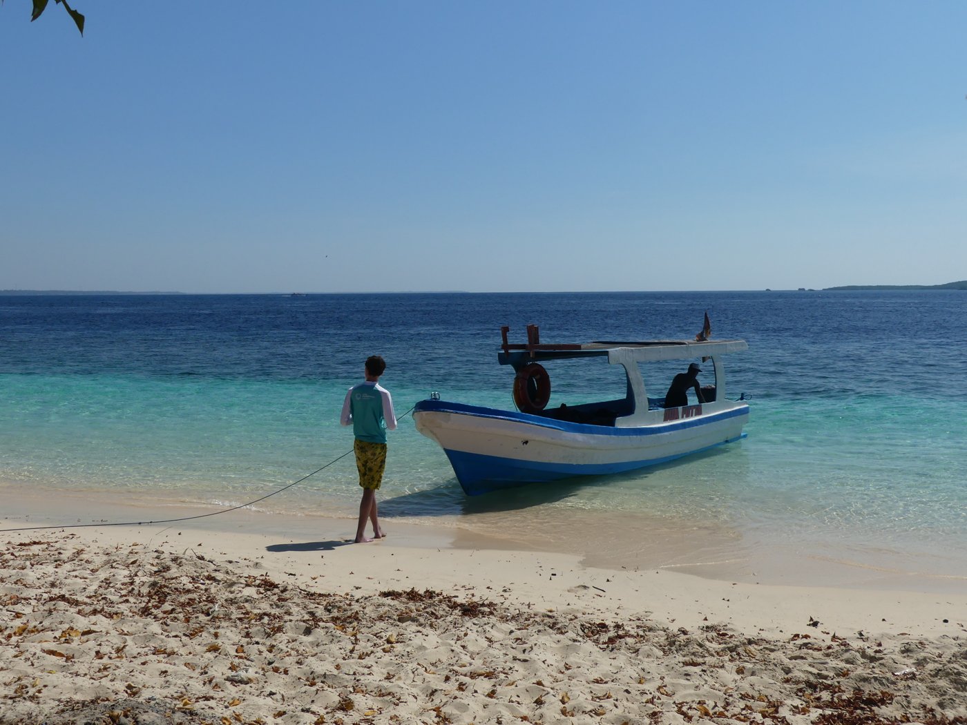 Our private boat on a turquoise beach