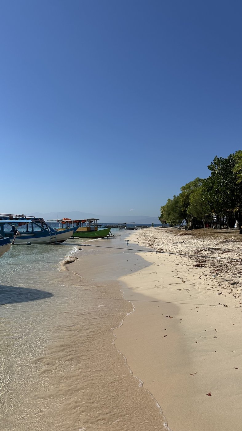 A quiet island beach with boats