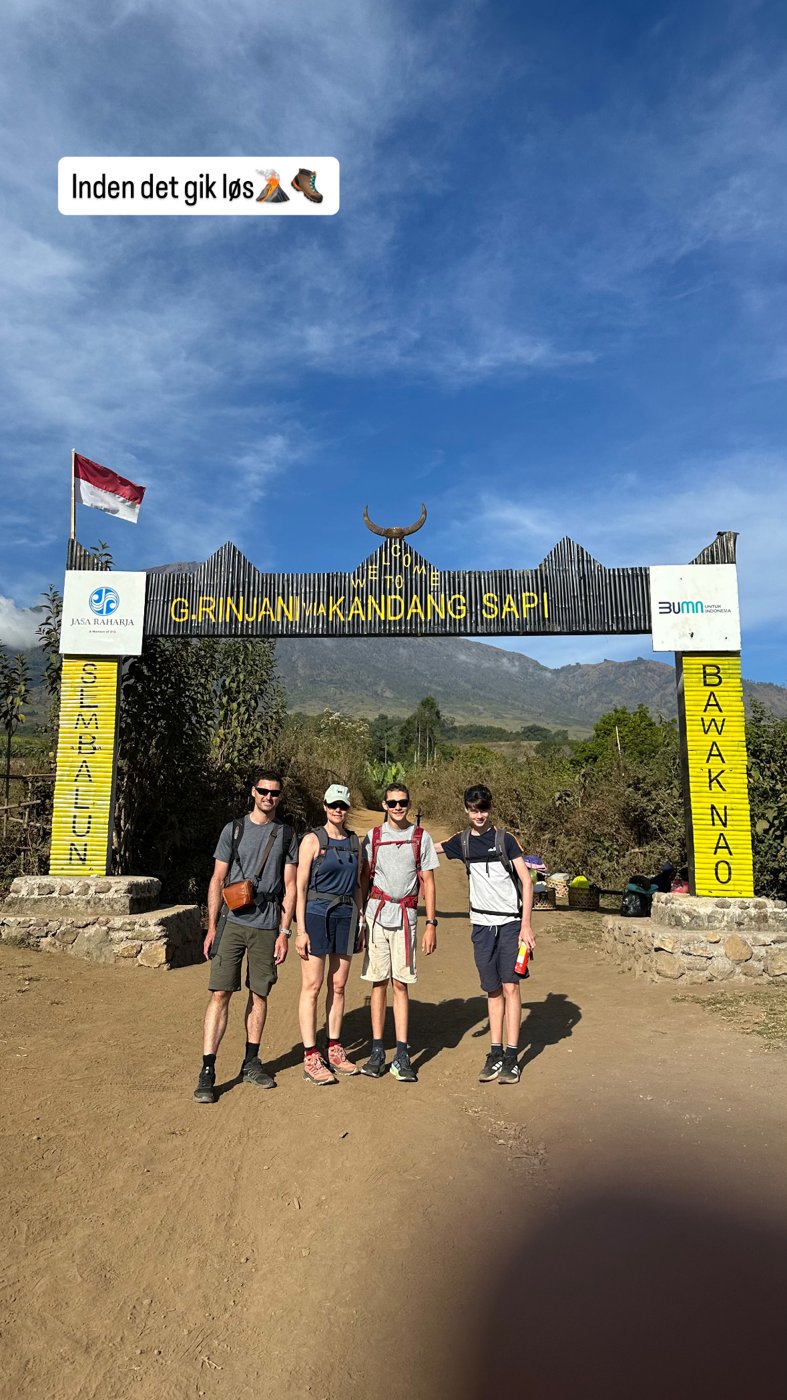 The family under the trek-start gate at Sembalun: Welcome to Gunung Rinjani via Kandang Sapi