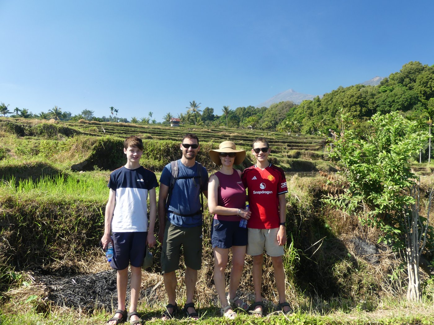 Family group photo among the green rice fields