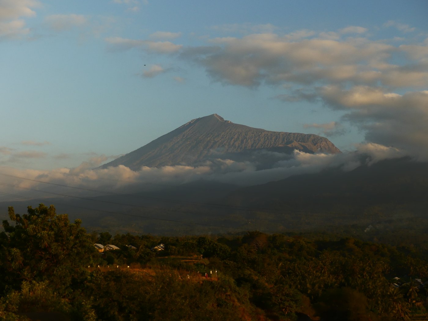 The volcano silhouetted across the water at sunset