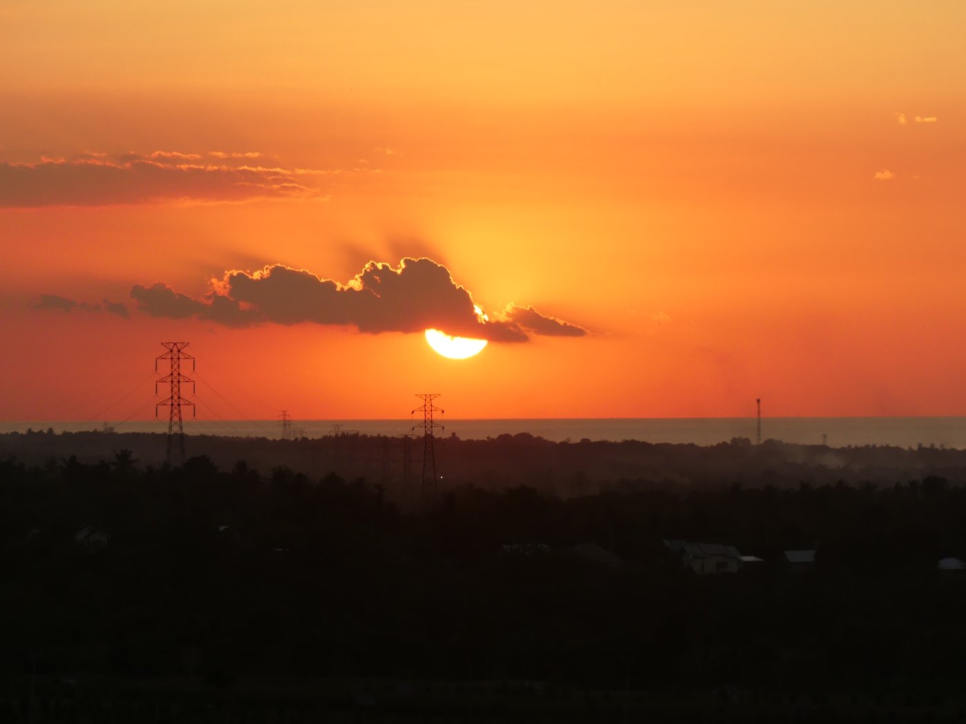 The sun setting over the sea and rice fields