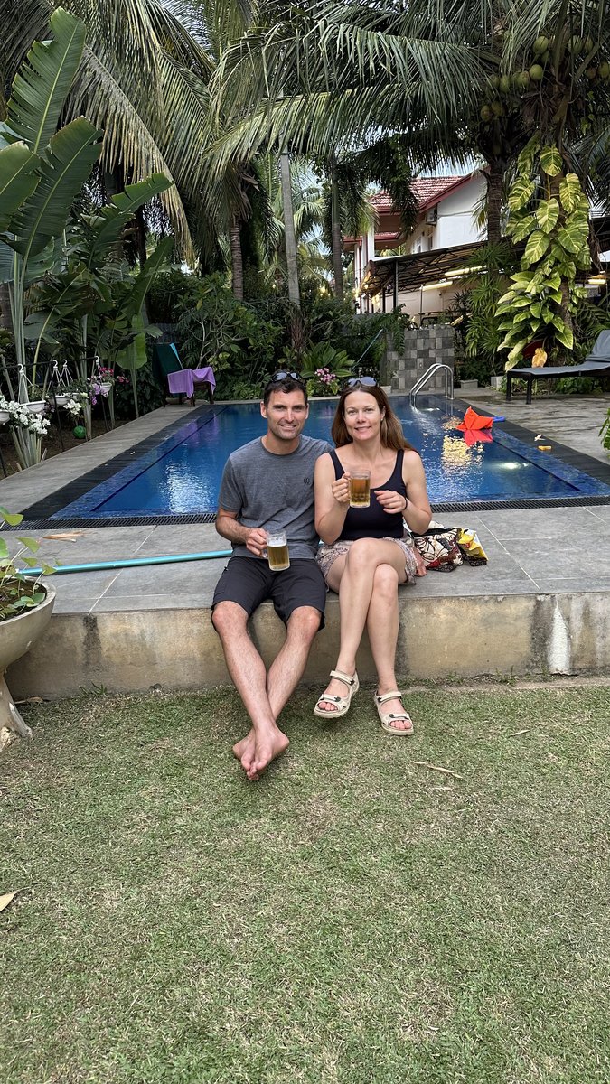 Line and Jesper with drinks by the Negombo hotel pool in the green garden