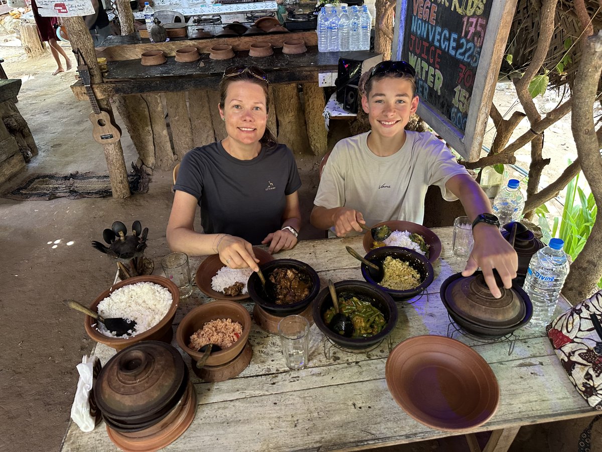 Line and Noah sitting down to the finished spread of rice and curries