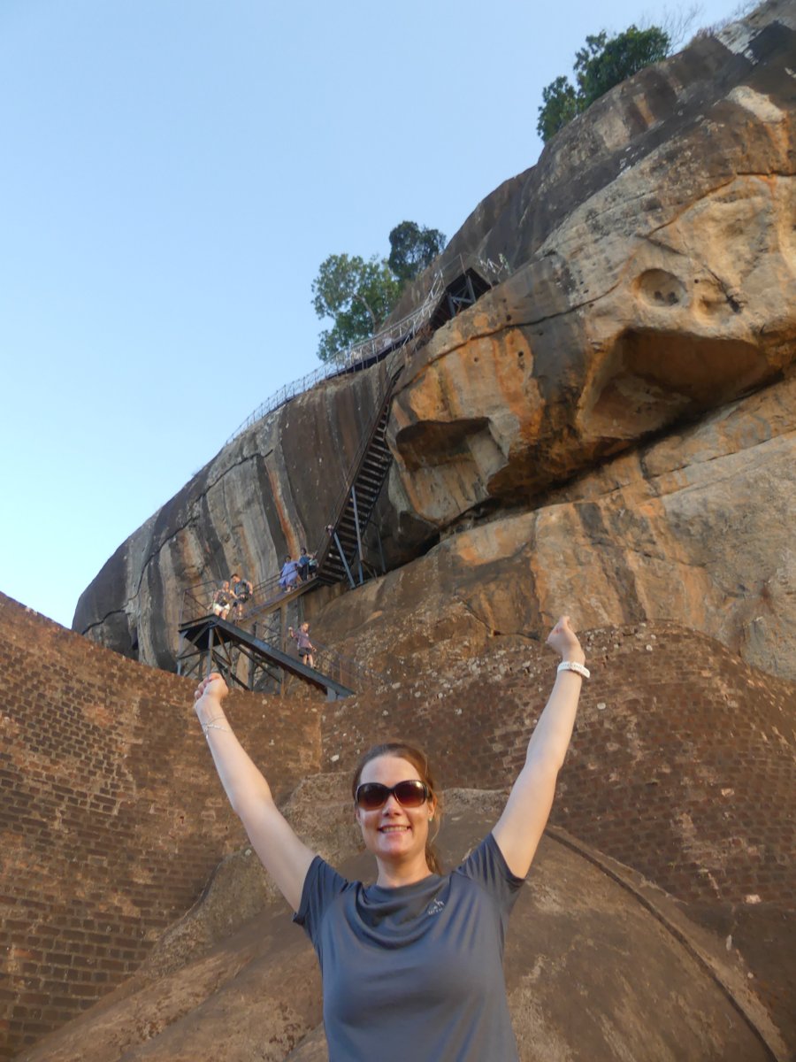 Line, arms raised in triumph at the Lion's Paw terrace with the staircases behind