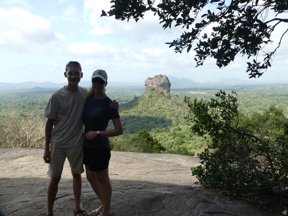 Line and Noah on Pidurangala with the Sigiriya Lion Rock rising from the jungle behind