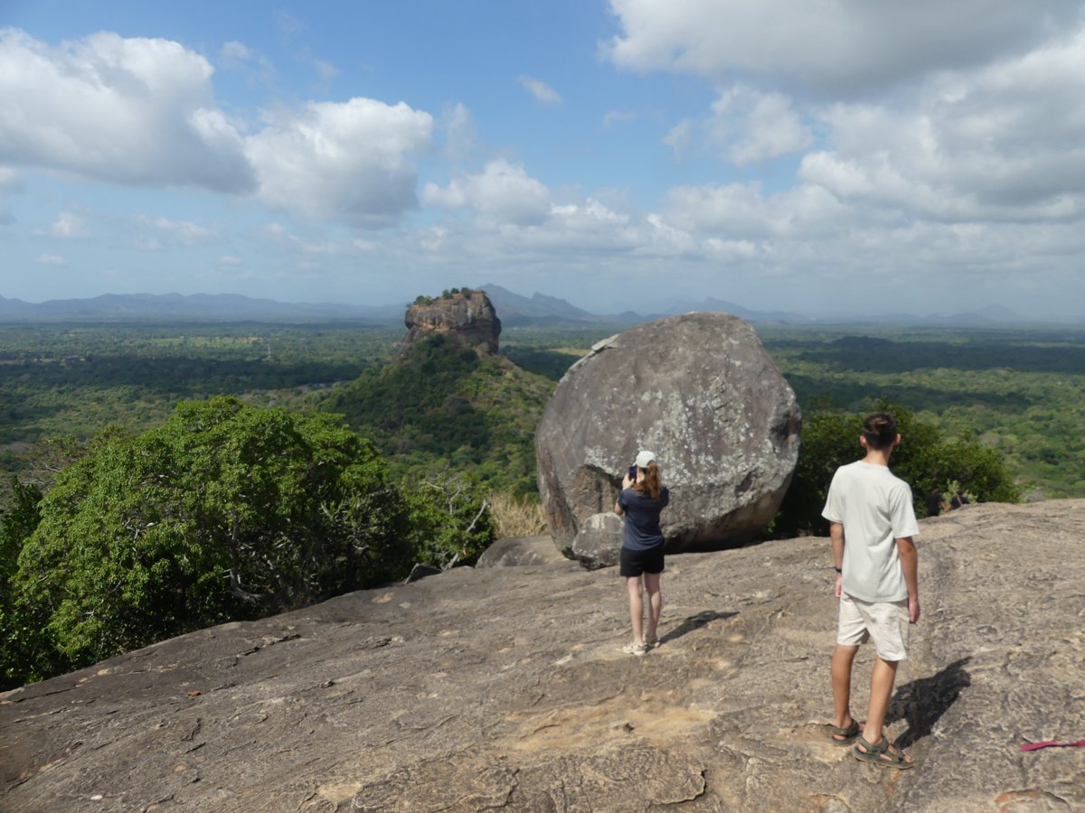 The top of Pidurangala with a huge round boulder and the Lion Rock in the distance