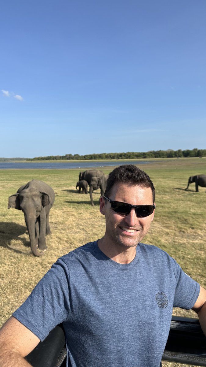 Jesper's selfie in the jeep with elephants and calves grazing right behind him