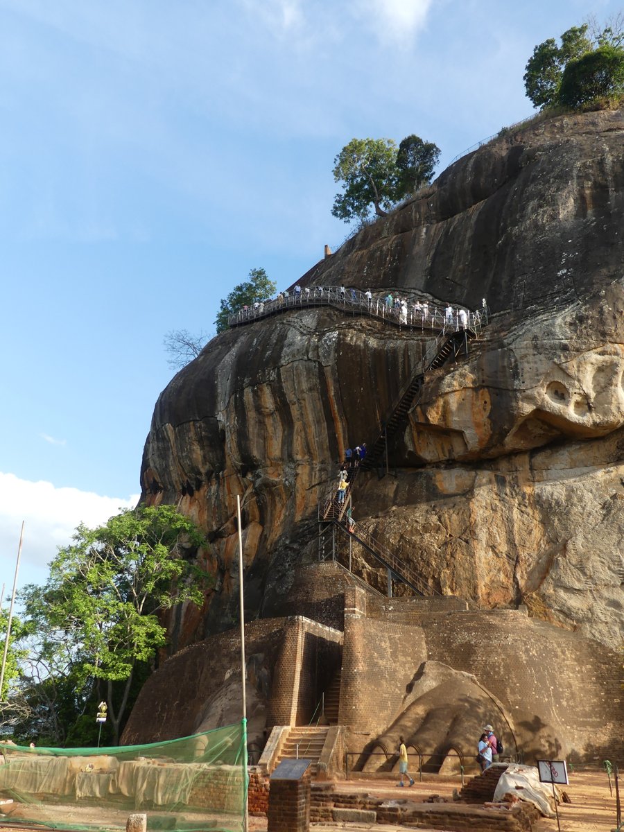 Metal staircases and crowds clinging to the sheer upper face of Sigiriya