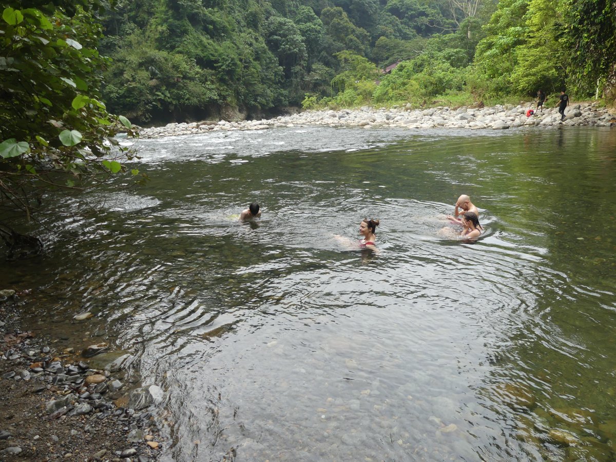 The family swimming in the cool river after the first day of trekking